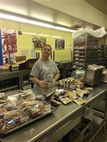 Cafeteria worker preparing meals