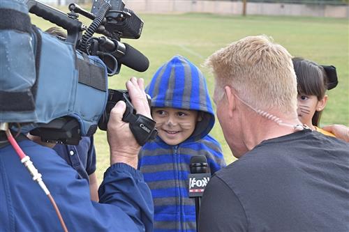 A student being interviewed by a news reporter.